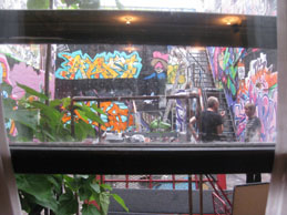 The back of the salon faces a courtyard of graffiti regularly updated by artists in the area